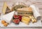 Cheese collection, marble board with French cheeses brie, tomme, matured goat cheese, morbier  served with fresh raspberries and