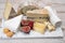 Cheese collection, marble board with French cheeses brie, tomme, matured goat cheese, morbier  served with fresh raspberries and