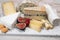 Cheese collection, marble board with French cheeses brie, tomme, matured goat cheese, morbier  served with fresh raspberries and