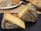 Cheese collection, piece of cow milk Dutch gouda cheese with dried aromatic cumin seeds close up