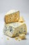 Cheese collection, piece of gouda cheese with blue mold and nuts close up- AI Generated