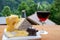 Cheese collection, Swiss cow cheese emmental, tomme and dark chocolate, glass of red wine from Savoie and mountains village in