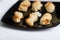 Cheese cookies served in a black plate