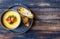 Cheese cream soup with grilled shrimp on a wooden background