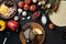 Cheese, different vegetables on black table. Ingredients for traditional italian pizza.