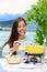 Cheese fondue - woman eating Swiss food