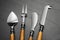 Cheese knives and fork on black stone table, flat lay