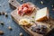 Cheese and meat platter. Spanish ham jamon serrano or Italian prosciutto crudo, sliced Italian hard cheese pecorino toscano