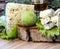 Cheese with mold on a green lettuce leaf with figs on a wooden background. Golden shot glass with alcohol