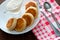 Cheese pancakes with sour cream on a white plate with fork and teaspoon. Can be used for menu design, culinary sites