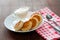 Cheese pancakes with sour cream on a white plate with a fork, a teaspoon . Can be used for menu design, culinary sites