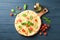 Cheese pizza, tomatoes and olive oil on wooden background