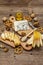Cheese plate antipasti with smoked and blue cheese, crackers, honey, walnuts and ripe pear. Traditional snack recipe idea. Wooden