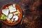 Cheese plate with Brie, Camembert, Roquefort, blue cream cheese, grape and nuts. Dark background. Top view. Copy space