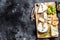 Cheese plate with Camembert, brie and blue cheese with grapes and walnuts. Black background. Top view. Copy space