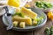 Cheese plate with delicous cheese slices and a cheese knife, wooden table