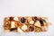 Cheese plate. French cheese with nuts, grape, berries, dried fruits and honey on cutting board on white. Camembert, Livarote, Pont