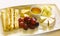 Cheese plate with honey saucer grapes