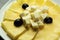 Cheese plate. Many kinds of cheese on a plate.Sliced yellow cheese with olives