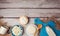 Cheese on plate and milk bottle on wooden rustic background. Healthy eating concept background. View from above.