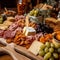 Cheese plate with prosciutto, salami, grapes, crackers and nuts