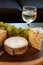 Cheese plate and wine including chardonnay, gourmet crackers