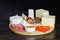 Cheese platte with different cheeses, meats on wooden board