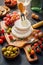 Cheese platter with brie, Camembert, grapes, olives and tomatoes