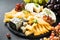 Cheese platter with craft cheese assortment on slate board.