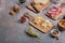 Cheese, salumi, olives, nut and grapes on wooden board, copy space