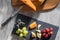 Cheese selection served with red white and black grapes. Flatlay snack food image