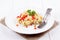 Cheese spaetzle with red bell pepper and parsley