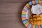 Cheese spread toasts with mango cut in cubes on a colorful plate on a wooden table