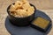 Cheese tasting, small pieces of old Dutch hard cheese and bowl with homemade dill-mustard sauce