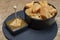 Cheese tasting, small pieces of old Dutch hard cheese and bowl with homemade dill-mustard sauce