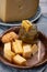 Cheese tasting, small pieces of old Dutch hard cheese and bowl with homemade dill-mustard sauce