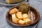 Cheese tasting, small pieces of old Dutch hard cheese and bowl with homemade dill-mustard sauce