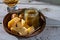 Cheese tasting, small pieces of old Dutch hard cheese and bowl with homemade dill-mustard sauce