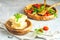 Cheese, tomatoes and arugula on the wooden plates