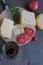 Cheese with tomatoes and coffee lies on a board on a brown table