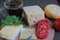 Cheese with tomatoes and coffee lies on a wooden board on a table