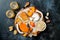 Cheese variety board or platter with cheese assortment, persimmons, honey and nuts. Black stone background.
