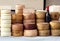 Cheese wheels of Pecorino and Sardinian ricotta in different stacks on a shelf of an outdoor market.