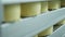 Cheese wheels stored on warehouse shelves of factory. Food production