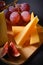 Cheeseboard with Hard and soft French cheese pieces, grape and fig cuts