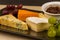 Cheeseboard platter with grapes and pickle