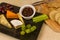Cheeseboard platter with grapes and pickle and crackers