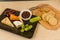 Cheeseboard platter with grapes and pickle and crackers