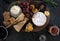 Cheeseboard with a variety of cheeses, crackers, fruit, honey, rosemary sprigs and chutney