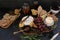 Cheeseboard with a variety of cheeses, crackers, fruit, honey, rosemary sprigs and chutney